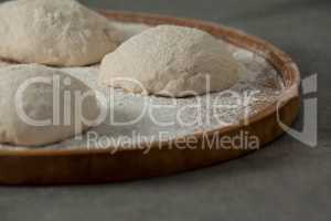 Pizza dough and flour on rolling board