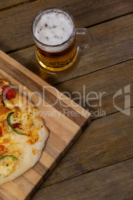 Delicious pizza served on pizza tray with a glass of beer