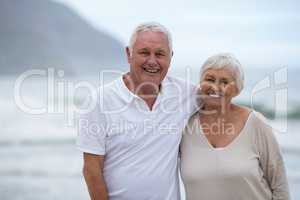 Portrait of senior couple standing together at beach