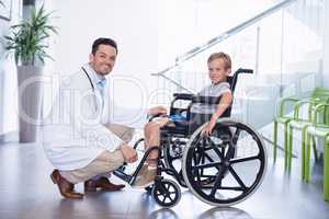 Portrait of smiling doctor and disable boy