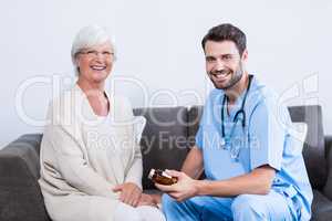 Portrait of doctor prescribing medicines to senior woman
