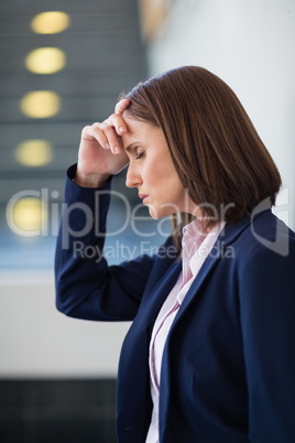 Worried businesswoman with hand on head