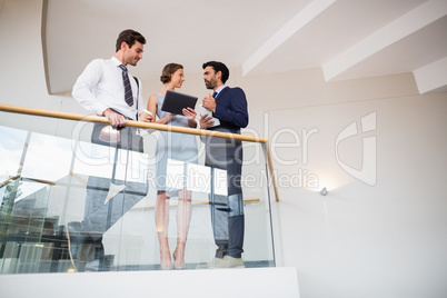 Business executives discussing over digital tablet