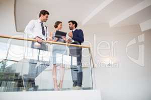 Business executives discussing over digital tablet