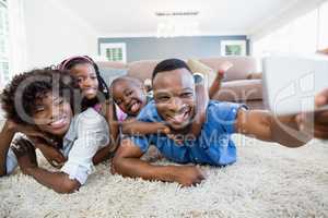 Happy family taking a selfie from mobile phone in living room