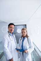 Portrait of female and male doctor standing in the passageway