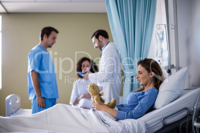 Beautiful woman playing with a teddy bear