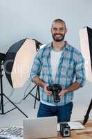 Male photographer working at desk