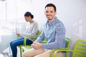 Portrait of smiling man sitting on chair