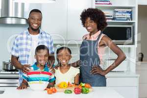 Parents and Kids standing in kitchen at home