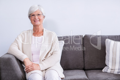 Portrait of senior woman sitting on sofa