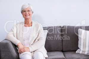 Portrait of senior woman sitting on sofa