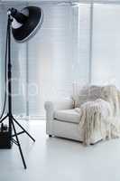 Armchair and spotlight in photostudio