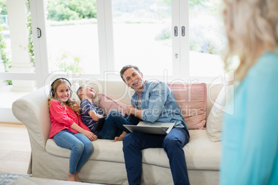 Father and kids having fun in living room