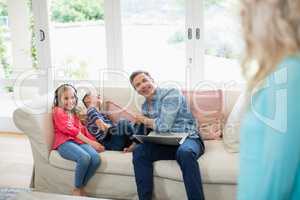 Father and kids having fun in living room