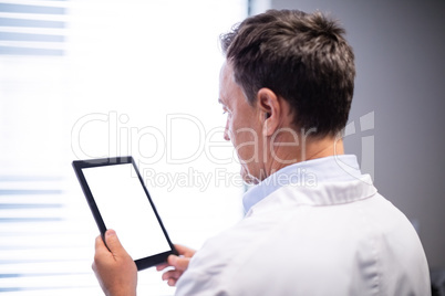 Male doctor using digital tablet