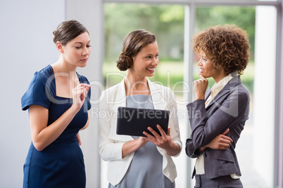 Business executives discussing over digital tablet