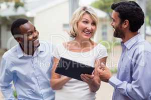 Business executives discussing over digital tablet