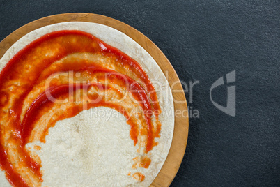Pizza dough with sauce