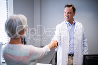 Doctor shaking hands with senior woman