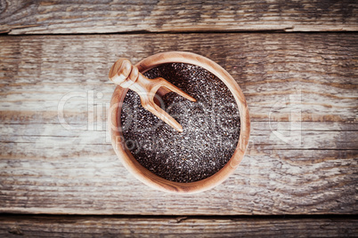 Chia Seeds with a spoon on a wooden table.