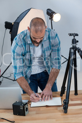 Male photographer working at desk