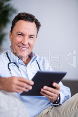 Portrait of doctor using digital tablet