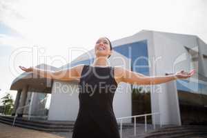 Beautiful and happy businesswoman with arms outstretched