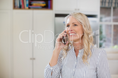 Woman talking on mobile phone at home