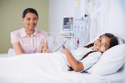 Portrait of nurse talking to a girl patient