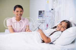 Portrait of nurse talking to a girl patient