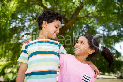 Two siblings having fun together in park