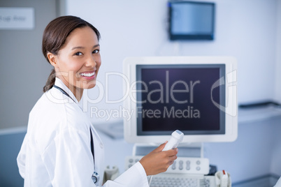 Portrait of doctor using ultrasound machine