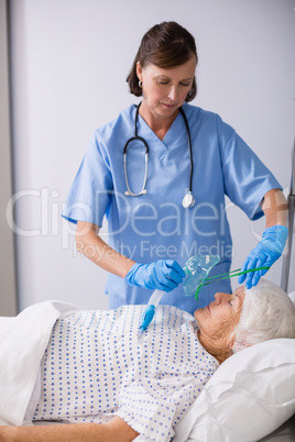 Doctor putting an oxygen mask on patient