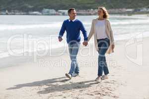 Mature couple holding hands while walking