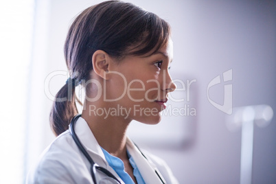 Thoughtful female doctor with stethoscope in ward