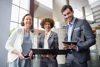 Business executives holding clipboard and digital tablet