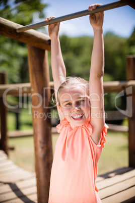 Girl playing on a playground ride in park