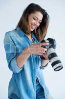 Female photographer reviewing captured photos in her digital camera