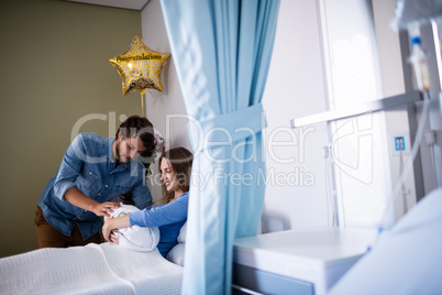 Couple with their new born baby in the ward