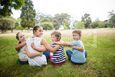 Kids sitting together in park