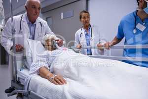 Doctor and nurse pushing emergency stretcher bed in corridor