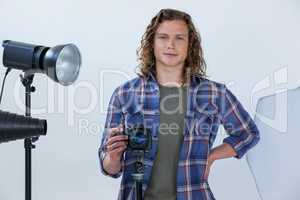 Photographer holding camera in photo studio