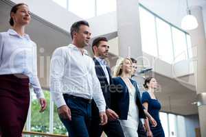 Business executives walking in a conference center lobby