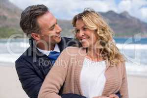 Mature couple embracing each other on the beach