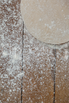 Pizza dough and flour on rolling board