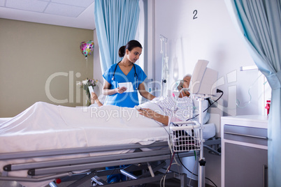 Female doctor consoling female senior patient