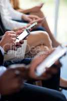 Close-up of business executives using mobile phone