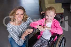 Portrait of smiling woman and disabled girl
