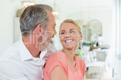 Couple embracing each other in kitchen